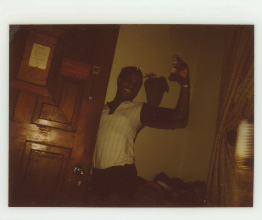 Download the full-sized image of A Photograph of Marsha P. Johnson Holding Cash Near a Door