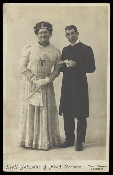 Download the full-sized image of Lyell Johnson & Fred Groome, music hall performers, one in drag, pose as a bride and a clergyman. Photographic postcard, 191-.